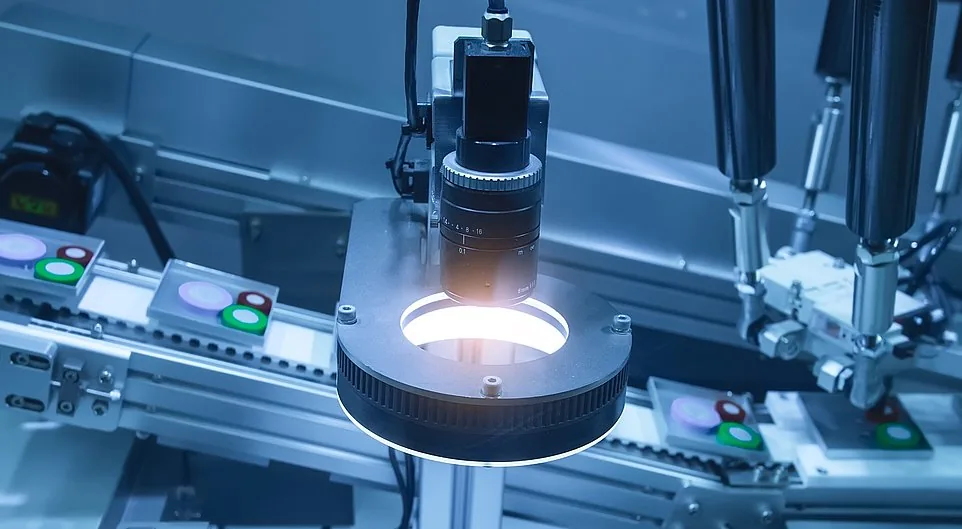 Machine-vision inspection station checking a machined part on the line